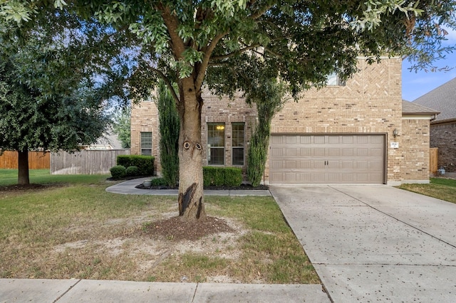 view of front of house featuring a garage and a front yard