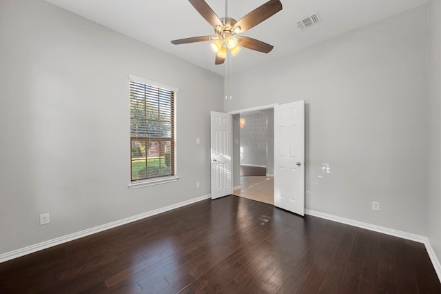 unfurnished bedroom featuring ceiling fan and dark hardwood / wood-style flooring