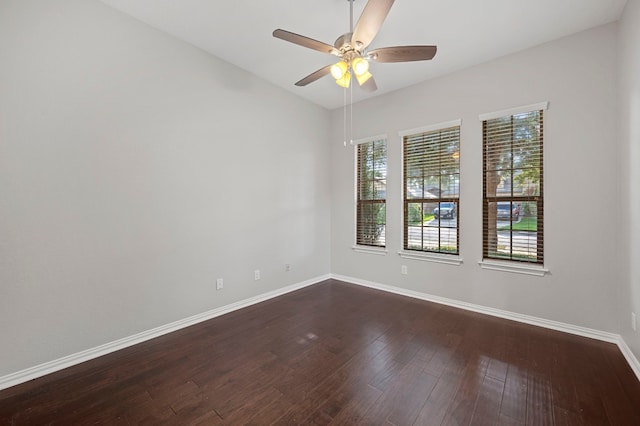 empty room with ceiling fan and dark hardwood / wood-style floors