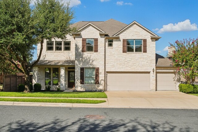 view of front of house featuring a garage and a front lawn