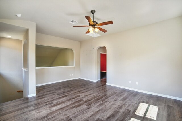 spare room with dark wood-type flooring and ceiling fan