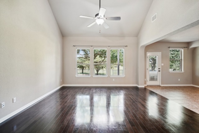 empty room featuring ceiling fan, plenty of natural light, and hardwood / wood-style floors