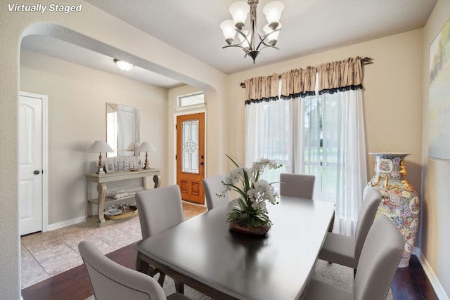 dining space with a chandelier and light hardwood / wood-style flooring