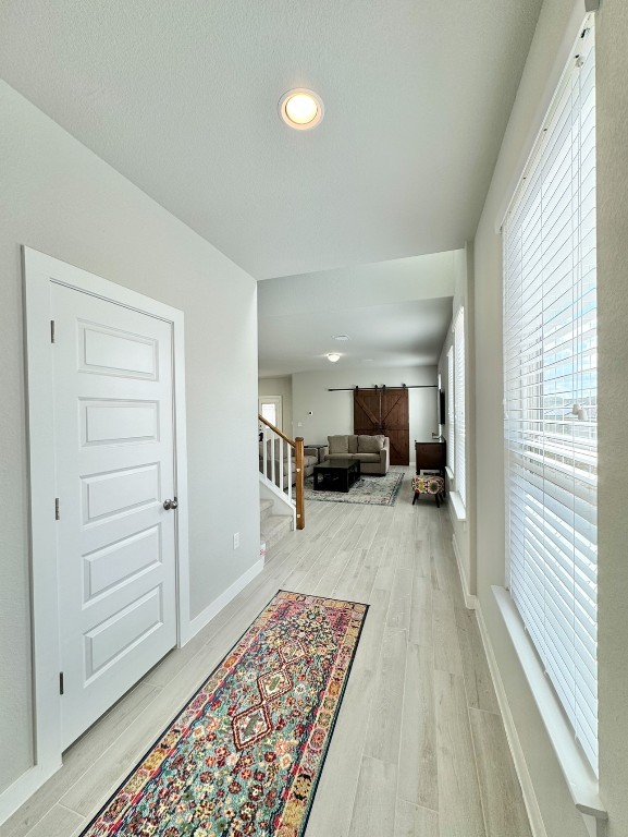 corridor with light wood-type flooring