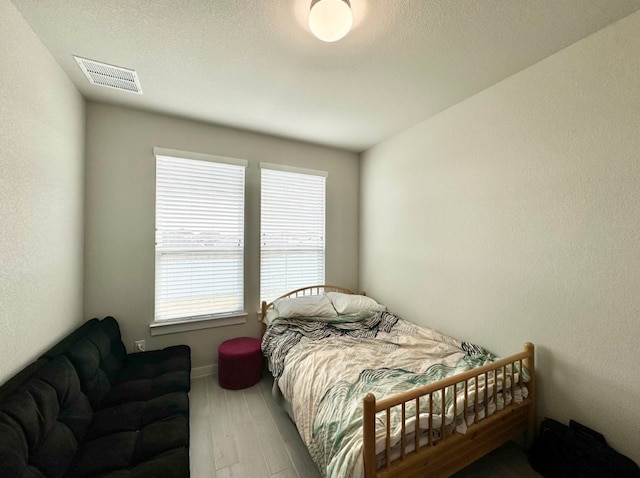 bedroom with hardwood / wood-style flooring