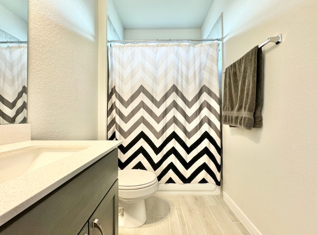 bathroom with hardwood / wood-style floors, vanity, toilet, and a shower with shower curtain