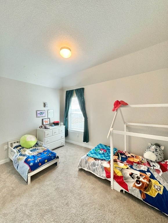 bedroom featuring a textured ceiling and carpet flooring