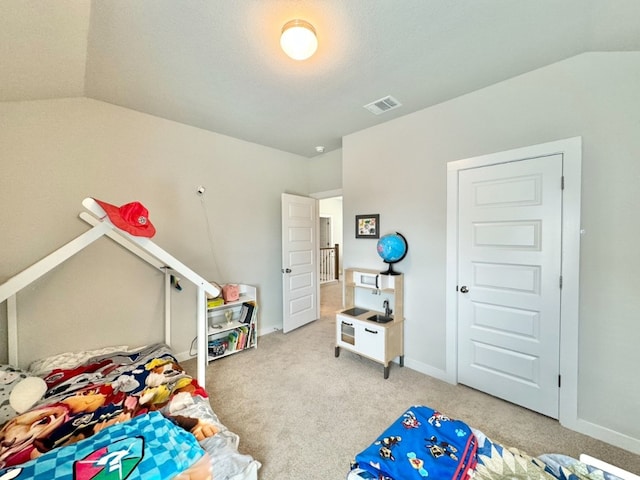 carpeted bedroom featuring vaulted ceiling