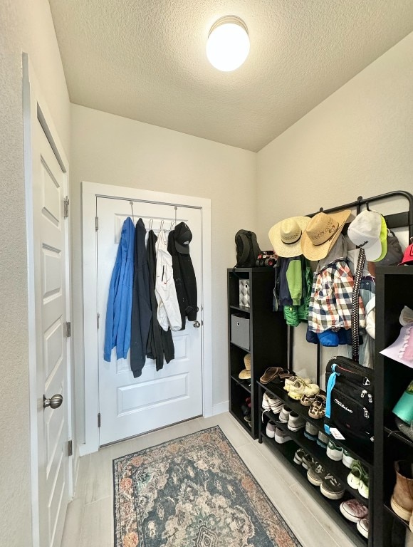 mudroom featuring a textured ceiling