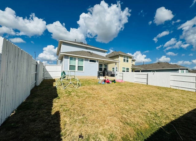 back of property featuring a lawn