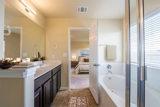 bathroom with a tub and vanity