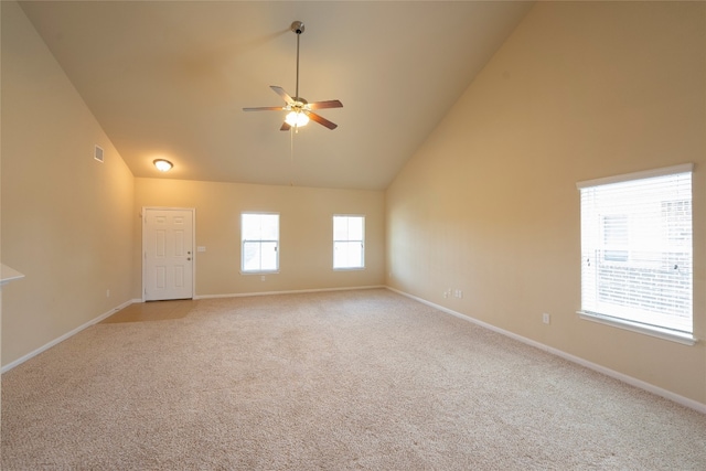 carpeted spare room with high vaulted ceiling and ceiling fan