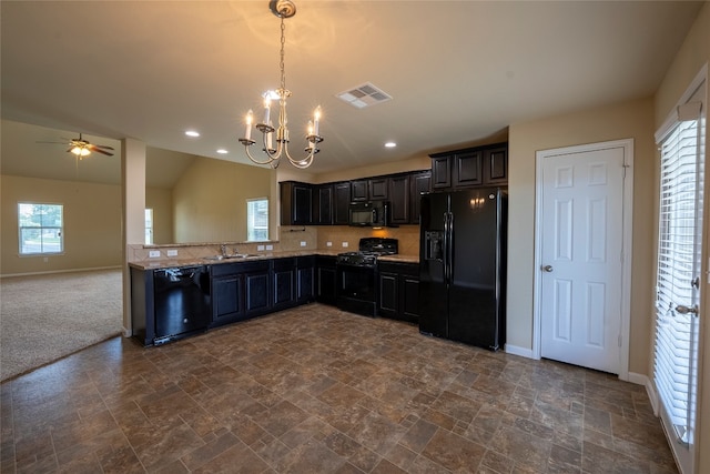 kitchen with black appliances, a healthy amount of sunlight, sink, and vaulted ceiling