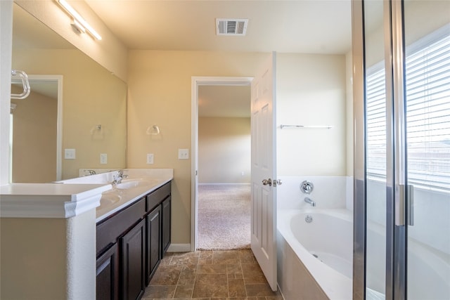 bathroom featuring a bath and vanity