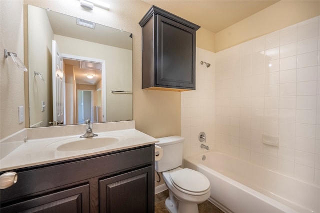 full bathroom with vanity, tiled shower / bath, and toilet