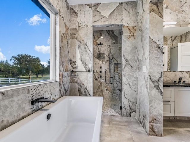 bathroom featuring tile walls, shower with separate bathtub, vanity, and concrete flooring