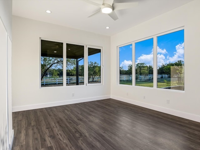 unfurnished room featuring dark hardwood / wood-style floors and ceiling fan