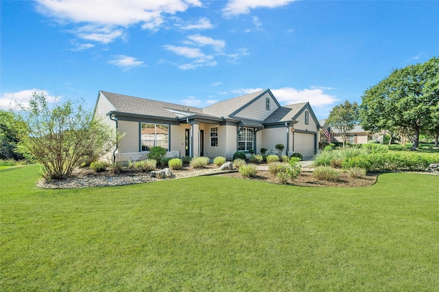 view of front of house with a front yard and a garage