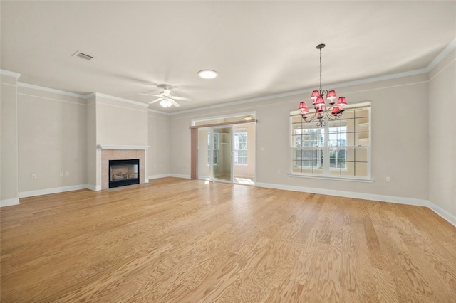 unfurnished living room featuring a tiled fireplace, light wood-type flooring, and ornamental molding