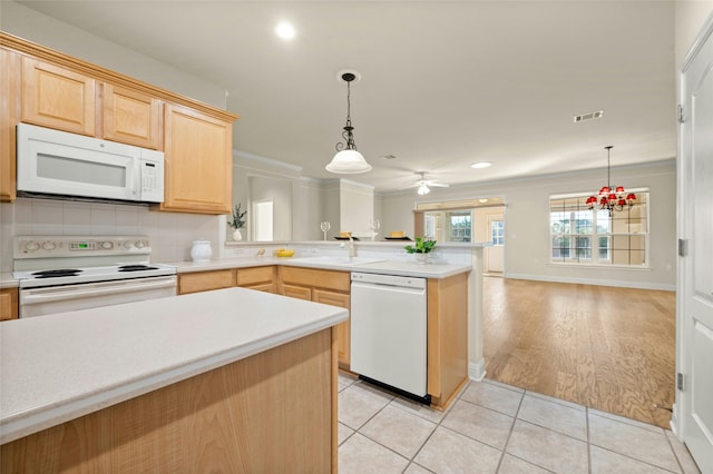 kitchen with light brown cabinetry, backsplash, white appliances, decorative light fixtures, and light tile patterned flooring