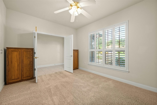 unfurnished bedroom with light carpet and ceiling fan