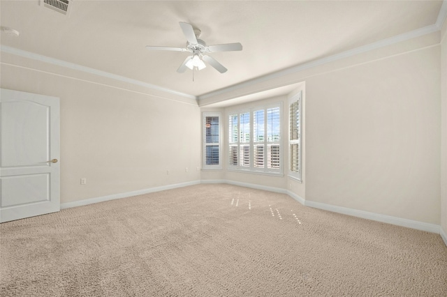 carpeted spare room with ceiling fan and ornamental molding