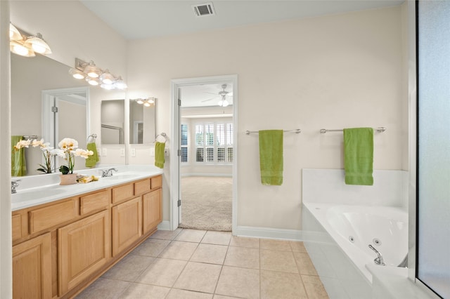 bathroom with ceiling fan, tile patterned flooring, vanity, and a relaxing tiled tub