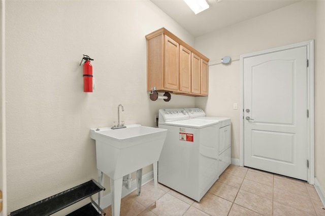 laundry area with cabinets, independent washer and dryer, and light tile patterned floors