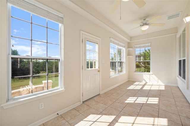 unfurnished sunroom featuring ceiling fan