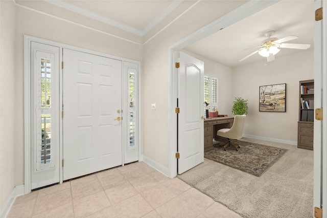 tiled foyer featuring ceiling fan and ornamental molding