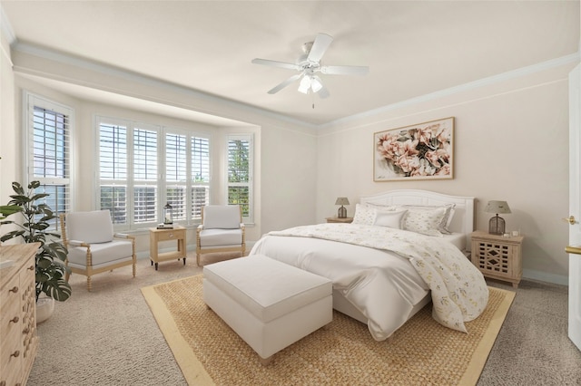 carpeted bedroom with ceiling fan and ornamental molding