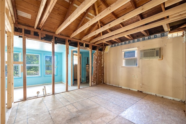 interior space with vaulted ceiling and a wall mounted AC