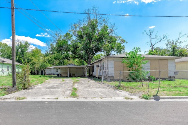 view of front facade with a carport and a front yard