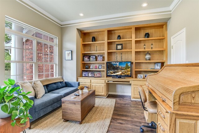 office space with built in desk, ornamental molding, and hardwood / wood-style flooring