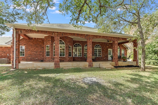 view of front of house featuring ceiling fan, a front lawn, a patio, and central air condition unit