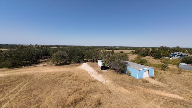 birds eye view of property with a rural view