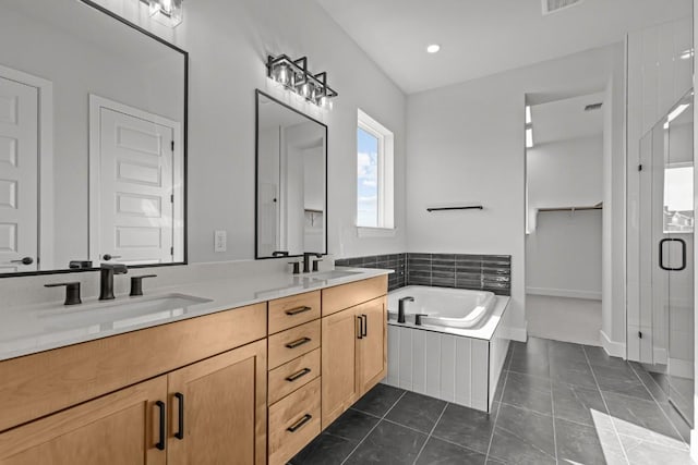 6512 Cowman Way, Austin, TX 78747 - full bath with double vanity, a bath, a stall shower, and a closet