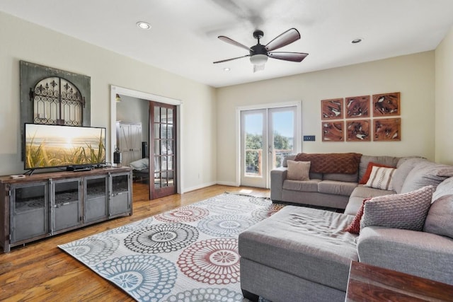 living room with ceiling fan and light hardwood / wood-style floors