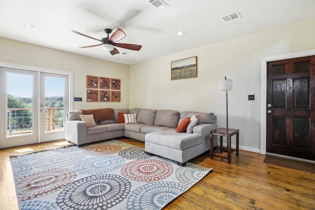 living room featuring ceiling fan and hardwood / wood-style floors