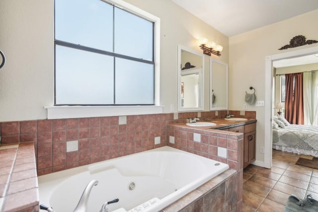 bathroom with vanity, tiled bath, and tile patterned floors