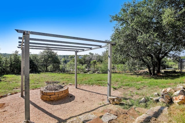 view of yard featuring a pergola and a fire pit