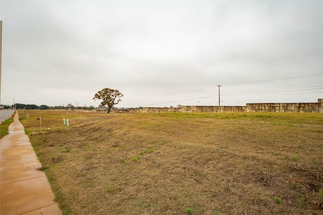 view of yard with a rural view