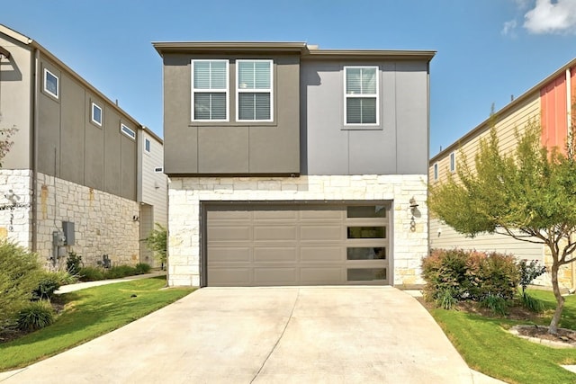 view of front of property featuring a garage and a front lawn