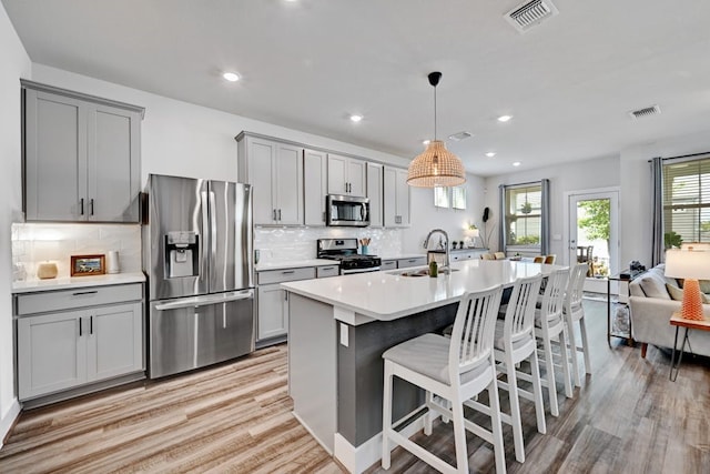 kitchen with stainless steel appliances, sink, and gray cabinetry