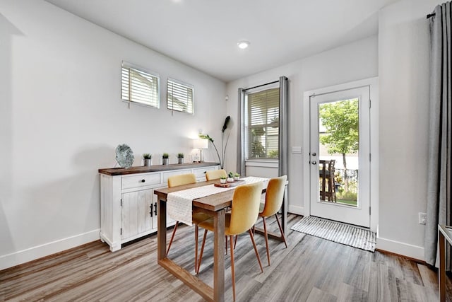 dining space with light hardwood / wood-style flooring