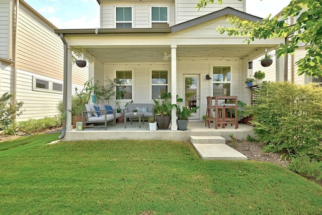 rear view of property with a yard and covered porch