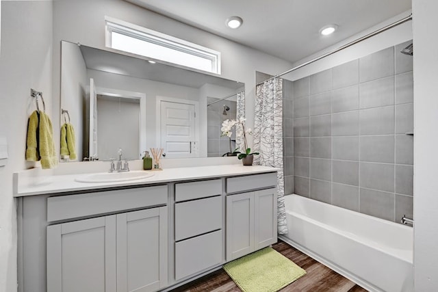 bathroom with hardwood / wood-style floors, shower / tub combo, and vanity