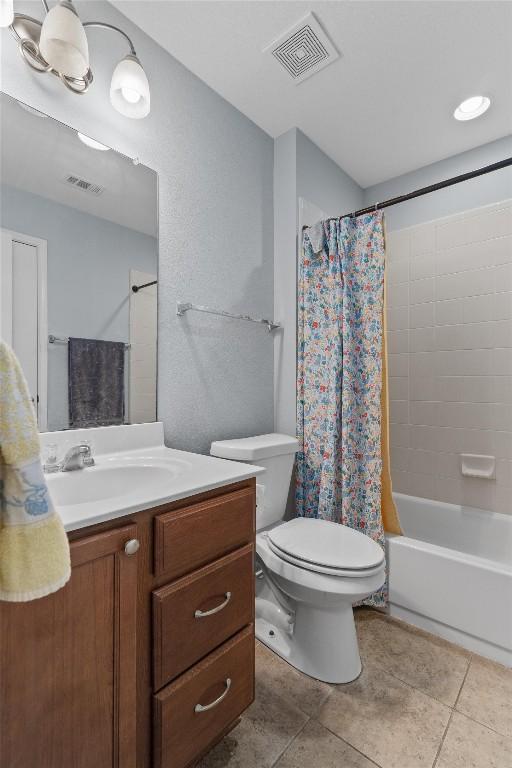 full bathroom with vanity, tile patterned flooring, toilet, and shower / bath combo with shower curtain