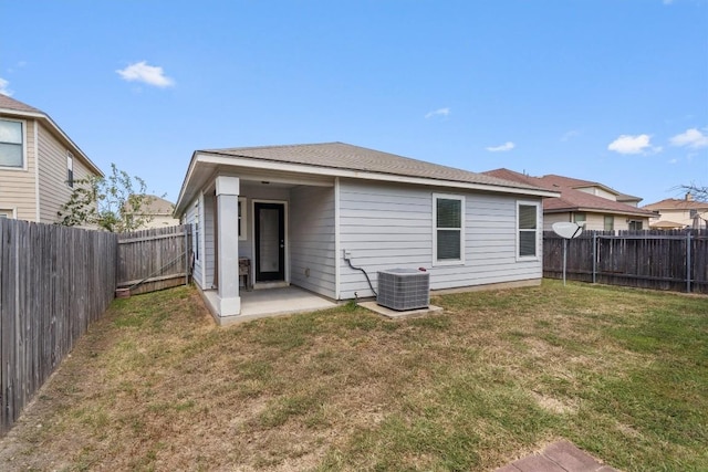 back of property featuring central AC, a patio area, and a lawn