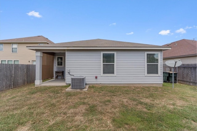 rear view of property with a patio, central AC unit, and a lawn